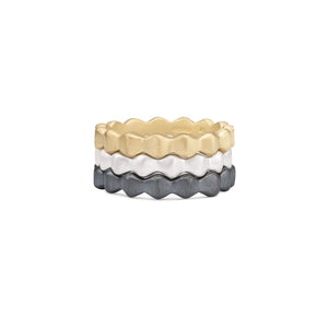 stacking rings in gold, silver and black